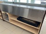 a large stainless steel sink in the middle of a kitchen