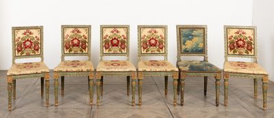six chairs with floral upholstered seats are lined up against a white wall