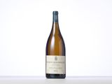 a bottle of white wine sitting on top of a table