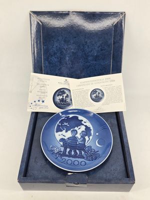 a blue and white plate in a blue box with a label on it