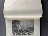an open book with a picture of a mountain scene on it