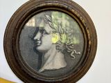 a picture of a woman with a flower in her hair on the wall