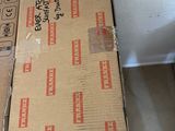 a cardboard box sitting on the floor next to a cardboard box