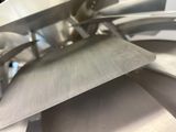 a close up of a knife cutting through a sheet of metal