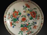 a plate with flowers on it on a black background