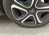 a close up view of a car ' s wheel on the street
