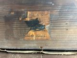 a picture of a piece of wood with a sticker on it