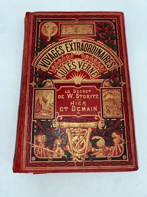 the front cover of a red book with gold trimmings on it