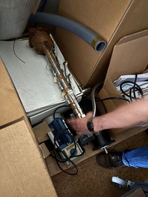 a man that is working on a machine in a box
