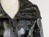 a mannequin wearing a black leather jacket on a mannequin stand