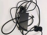 a picture of a black power cord and a charger on a white surface