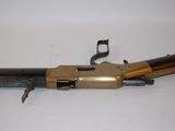 a close up of a gun on a white surface