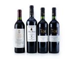 three bottles of red wine are lined up on a white surface