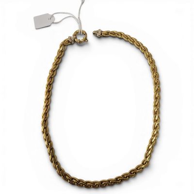a close up of a gold chain bracelet on a white background