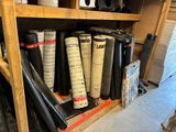 many rolls of black and white material on a shelf