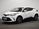 une Toyota C-HR blanche garée dans une pièce au sol à carreaux