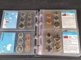 a lot of coins in a binder on the table