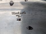 a close up of a silver plate on a table