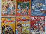 quatre bandes dessinées françaises posées sur une surface blanche