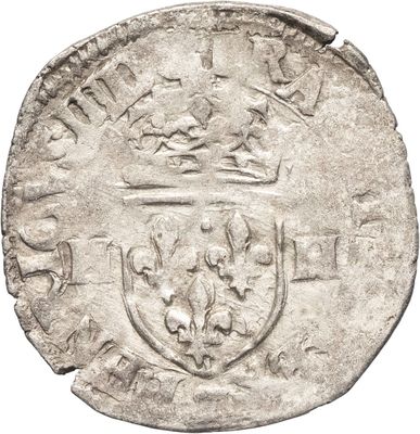 une pièce d'argent surmontée d'une couronne