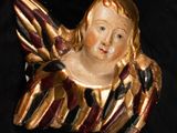 a gold and red angel on a black background