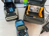 three cell phones and a printer on a table
