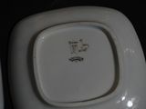 a white plate with a green and yellow design on it