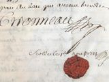 un morceau de papier portant un cachet de cire