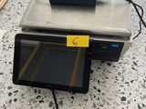 a tablet computer sitting on top of a table next to a laptop