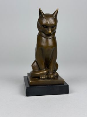 bronze statue of a cat sitting on a black base