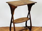 an old wooden table with a shelf on top of it on a hard wood floor