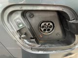 a close up of a car ' s fuel tank with a nozzle