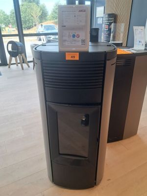 a black stove sitting in the middle of a room