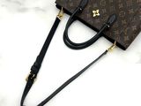 a louis vuitton handbag sitting on top of a marble counter