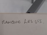 a piece of paper with writing on it and a pair of scissors in the background