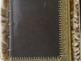 an old book in a box with gold trimming on it