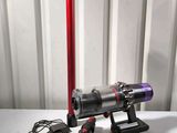 a picture of a vacuum and a cordless vacuum cleaner on a table