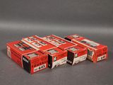 four boxes of red and black film sitting on top of a gray surface