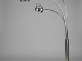 a chrome and marble floor lamp with three spheres on a marble base