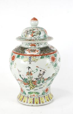 a white and red vase with a lid sitting on a table