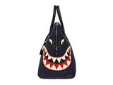 a black handbag with a shark face on the front