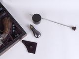 a box that has a tie bar, a bottle, and a pair of shoes in it