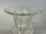 a clear glass vase with an animal design on it