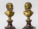 a pair of brass busts of children on marble bases