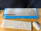 a computer keyboard and a mouse on a table