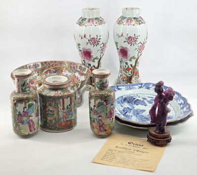 many different vases and plates on display on the table