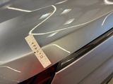 a sticker on the hood of a silver car