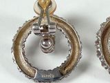 a pair of earrings that are sitting on a table