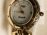 a picture of a gold watch with a chain around it