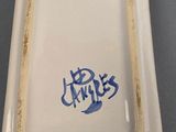 a white plate with blue writing on it on a table